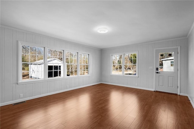 interior space featuring wood-type flooring and plenty of natural light