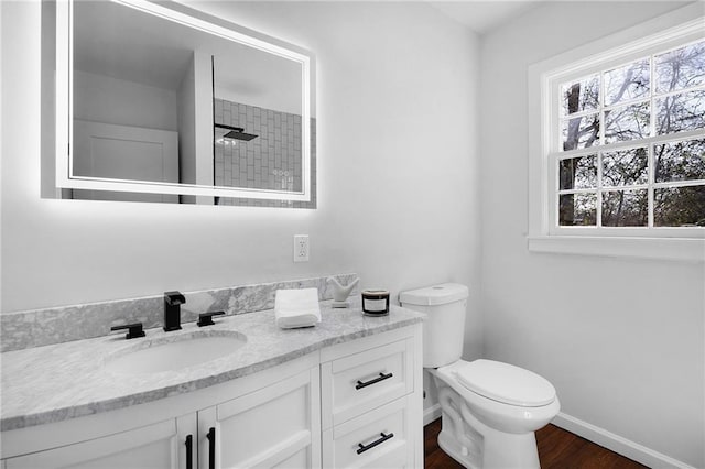 bathroom featuring vanity, wood-type flooring, toilet, and walk in shower