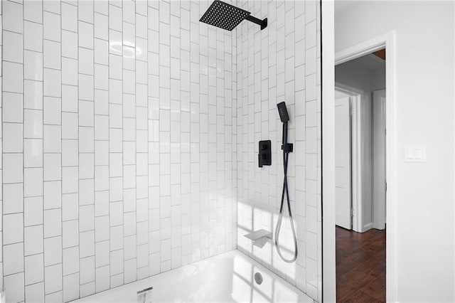 bathroom featuring wood-type flooring and tiled shower / bath combo