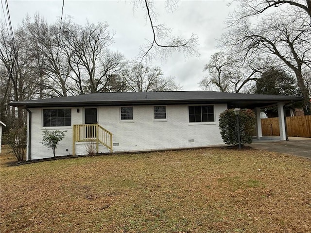 single story home featuring a front lawn and a carport