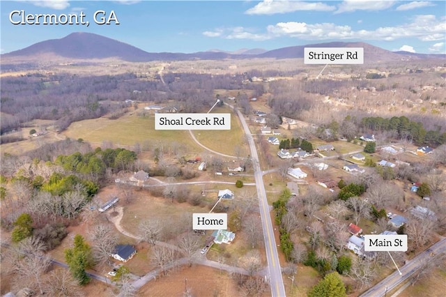 birds eye view of property with a mountain view