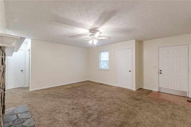 empty room with a textured ceiling, ceiling fan with notable chandelier, and light hardwood / wood-style flooring