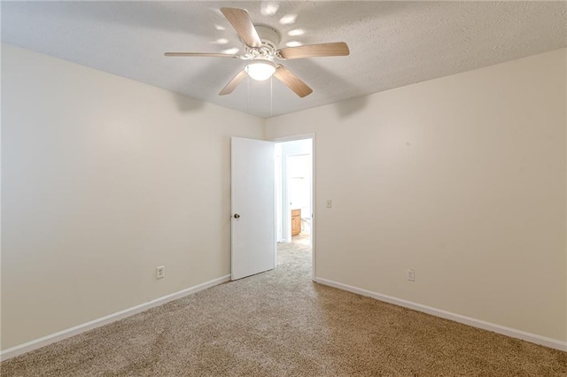 unfurnished room with carpet, ceiling fan, and a textured ceiling