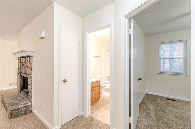 empty room with ceiling fan, carpet, and a textured ceiling