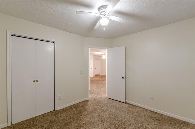 unfurnished room with carpet flooring, a textured ceiling, and ceiling fan