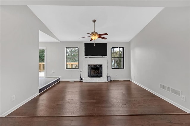 unfurnished living room featuring hardwood / wood-style floors, plenty of natural light, ceiling fan, and vaulted ceiling