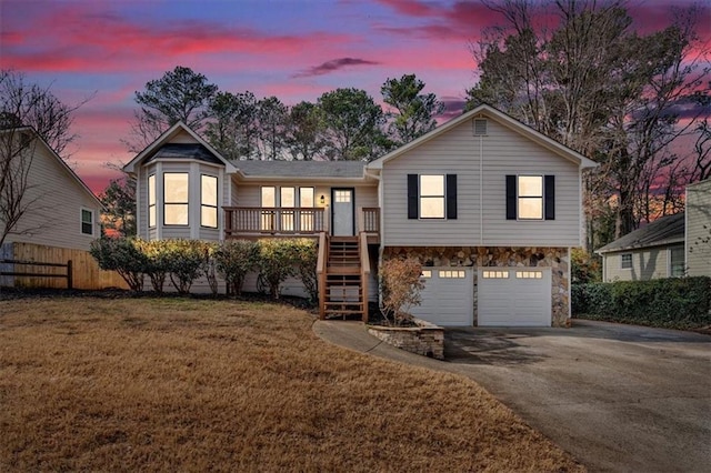 view of front of house featuring a garage and a lawn