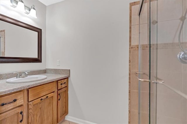 bathroom featuring vanity and a shower with shower door