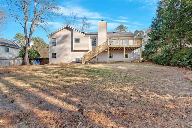 back of house with a yard and a deck