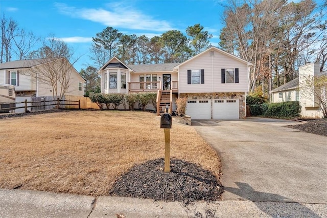 view of front facade featuring a porch, a garage, and a front lawn