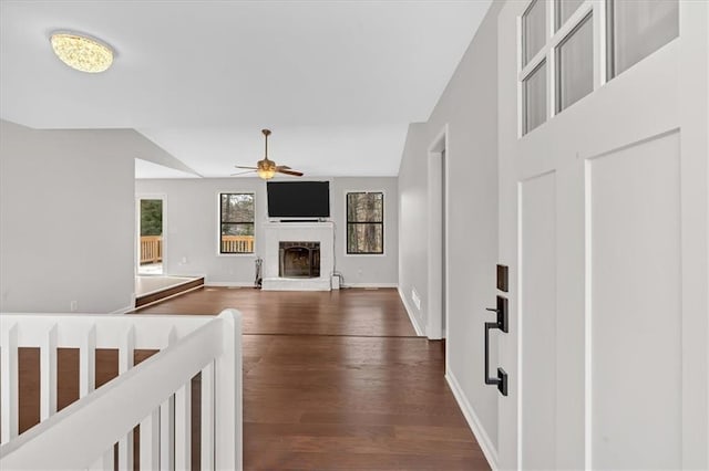 living room with ceiling fan, dark hardwood / wood-style flooring, and vaulted ceiling