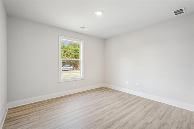 spare room featuring light wood-type flooring