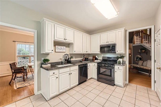 kitchen with light hardwood / wood-style floors, white cabinetry, and stainless steel appliances