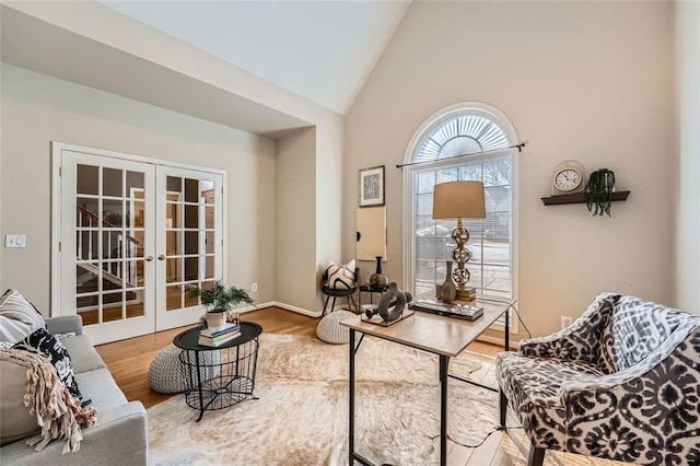 office with french doors, high vaulted ceiling, and hardwood / wood-style flooring