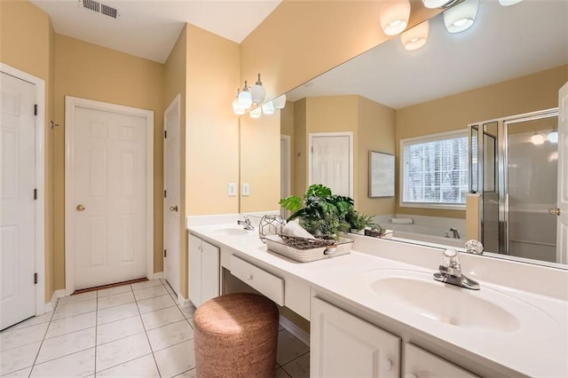 bathroom with plus walk in shower, vanity, and tile patterned floors