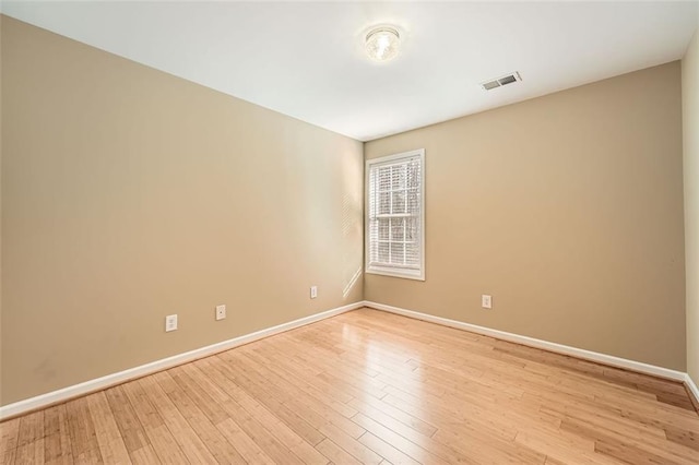 spare room with light hardwood / wood-style flooring