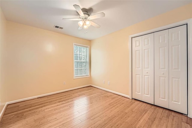 unfurnished bedroom with ceiling fan, a closet, and light hardwood / wood-style flooring