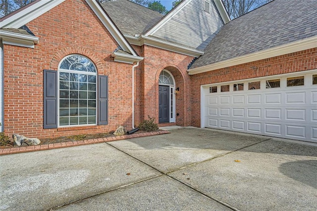 doorway to property with a garage