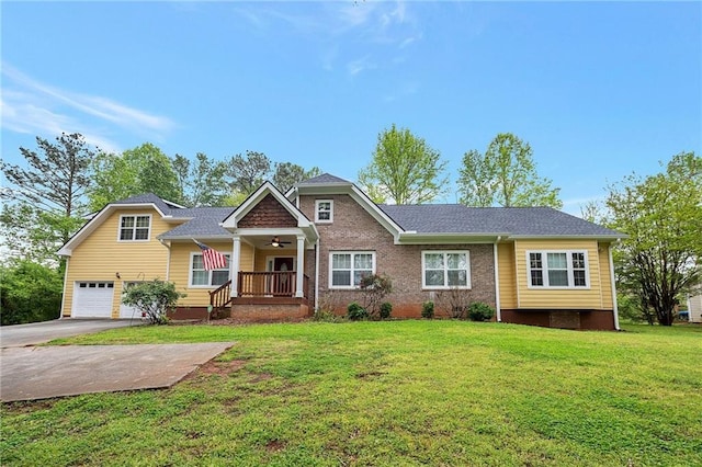 view of front of home featuring a garage, brick siding, a ceiling fan, driveway, and a front yard