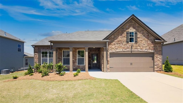 view of front of property with central AC unit, a garage, and a front lawn