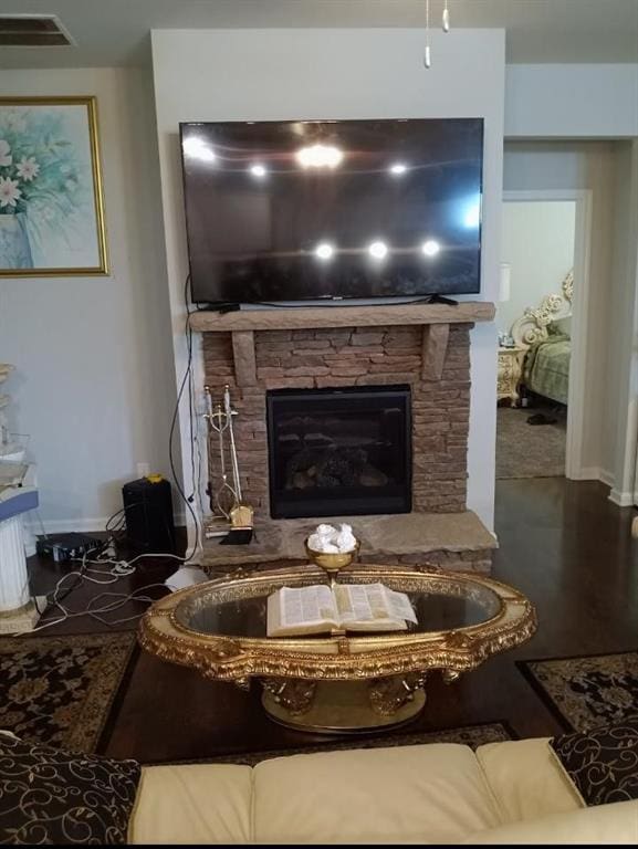 living room with a stone fireplace