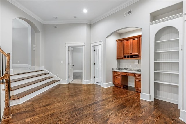 bar featuring visible vents, ornamental molding, built in features, dark wood finished floors, and built in study area