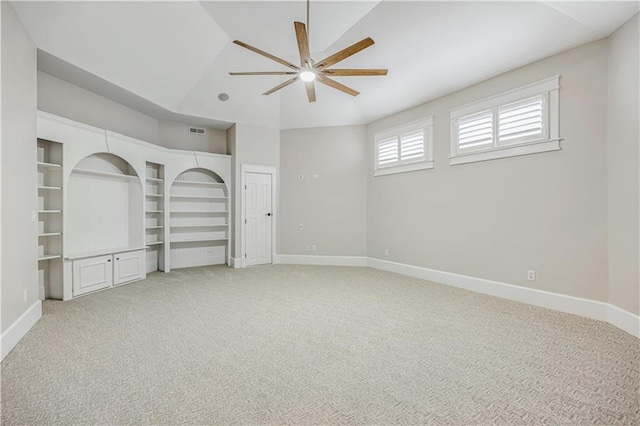 unfurnished bedroom with light carpet, visible vents, lofted ceiling, and baseboards