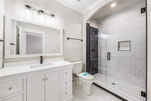 bathroom with vanity, crown molding, toilet, and a stall shower