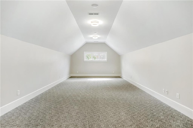 bonus room featuring baseboards, visible vents, lofted ceiling, and carpet floors