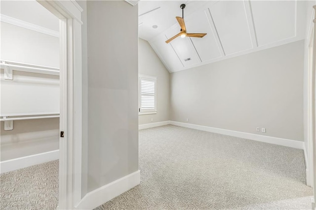 unfurnished bedroom with visible vents, baseboards, carpet, vaulted ceiling, and a ceiling fan