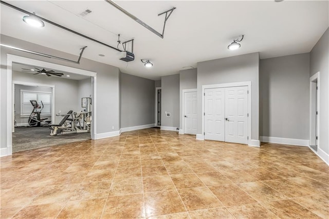 garage with visible vents, baseboards, and a garage door opener