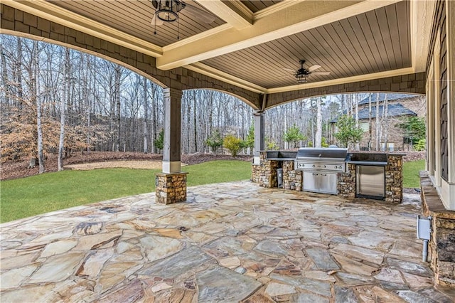 view of patio / terrace featuring ceiling fan, area for grilling, and a grill