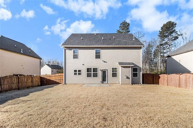 back of property featuring a yard and a patio