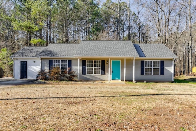 ranch-style home with roof with shingles and a front lawn