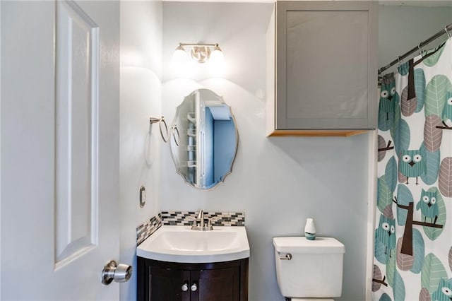 bathroom with toilet, tasteful backsplash, a shower with shower curtain, and vanity