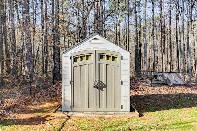 view of shed featuring fence