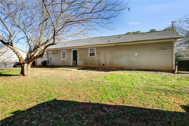 rear view of house featuring a lawn and a patio