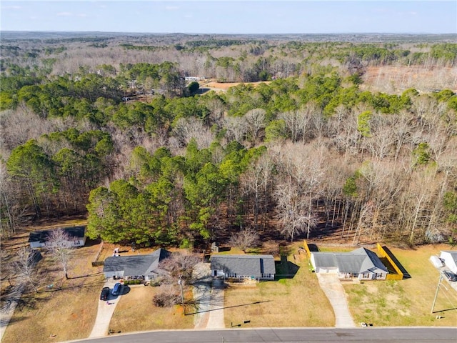 bird's eye view featuring a wooded view