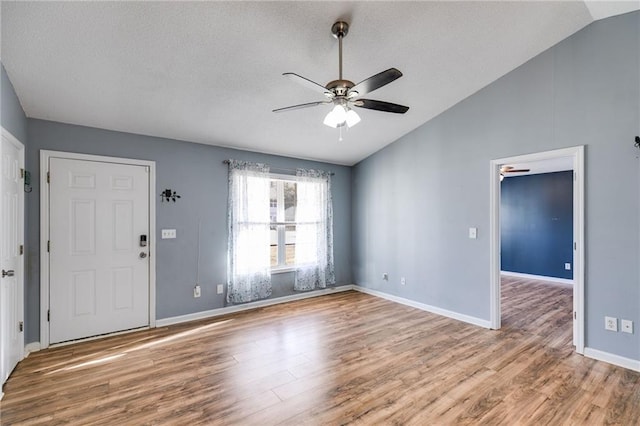 interior space featuring lofted ceiling, ceiling fan, and wood finished floors