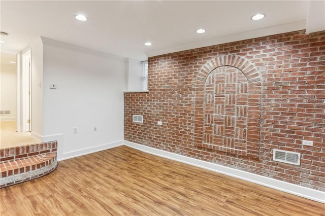 869 Briarcliff Rd NE Unit B25, Atlanta, GA 30306 - interior space featuring visible vents, baseboards, brick wall, light wood-style flooring, and recessed lighting