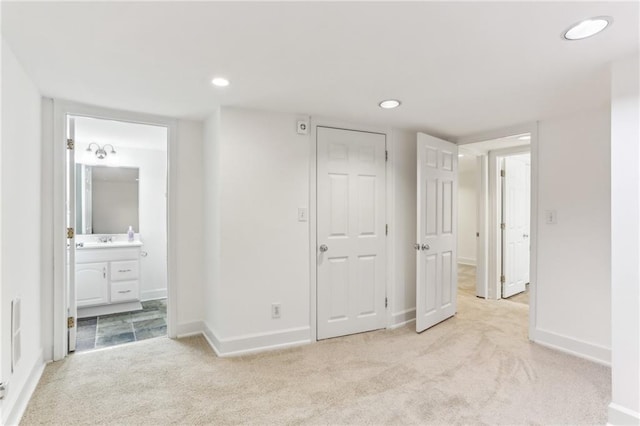 869 Briarcliff Rd NE Unit B25, Atlanta, GA 30306 - unfurnished bedroom with connected bathroom, recessed lighting, a sink, carpet flooring, and baseboards