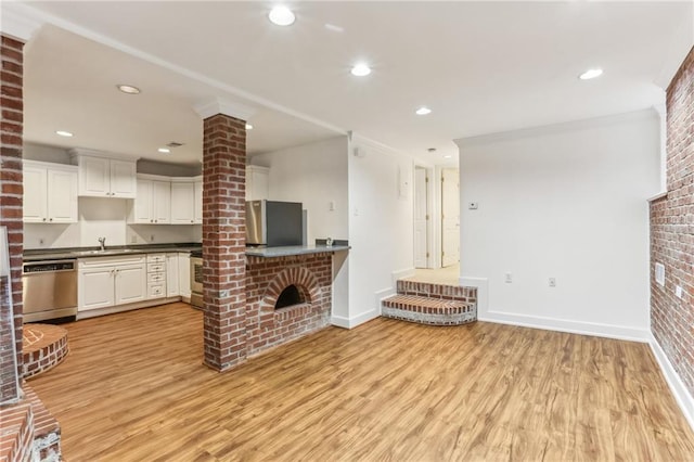 869 Briarcliff Rd NE Unit B25, Atlanta, GA 30306 - unfurnished living room with light wood-type flooring, a brick fireplace, and baseboards
