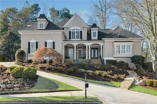 view of front of home featuring covered porch and stucco siding