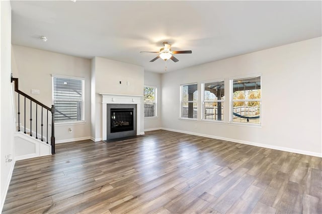 unfurnished living room featuring ceiling fan and wood-type flooring