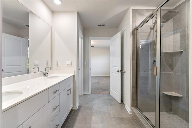 bathroom featuring tile patterned flooring, vanity, and an enclosed shower