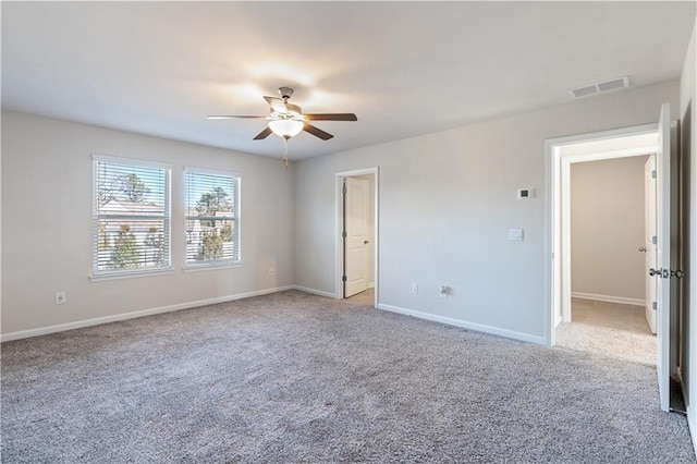 empty room featuring light colored carpet and ceiling fan