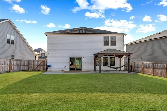 rear view of property with a gazebo, a yard, and a patio area