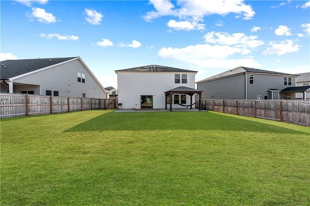 back of property featuring a gazebo, a yard, and a patio area