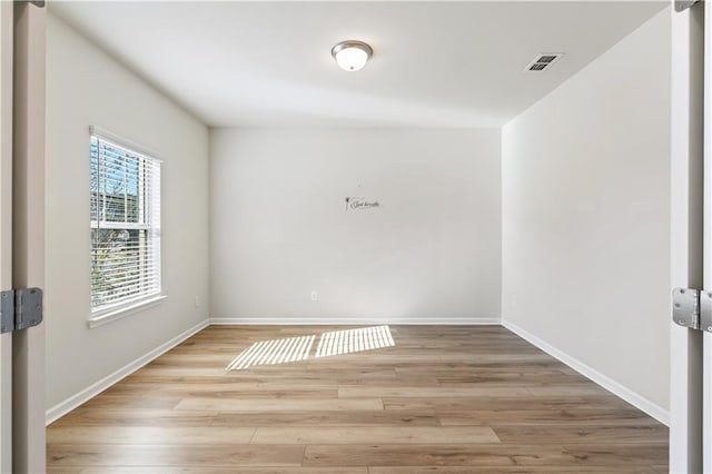 unfurnished room featuring light hardwood / wood-style floors