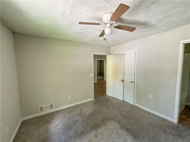 unfurnished bedroom with a closet, a textured ceiling, carpet flooring, and ceiling fan